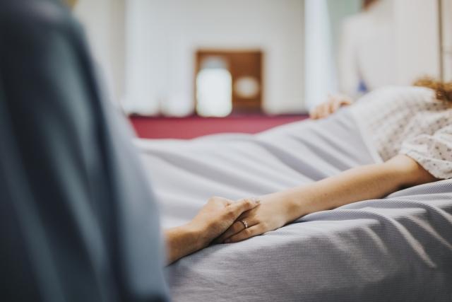 patient bed holding hands