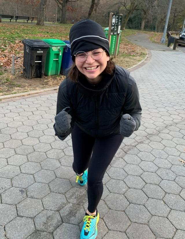 An image of Cody, leaning forward and smiling in exercise attire and running shoes