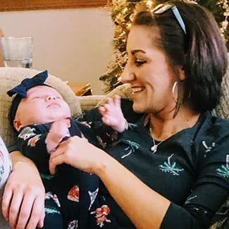 Stephanie S. holding a baby
