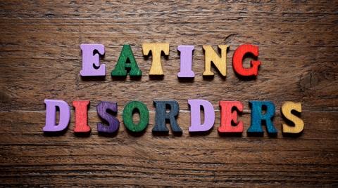 Block letters spelling the words eating disorders