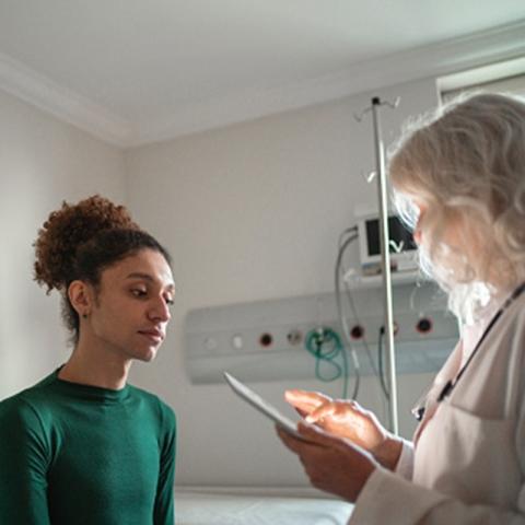 A patient is being assessed by a doctor